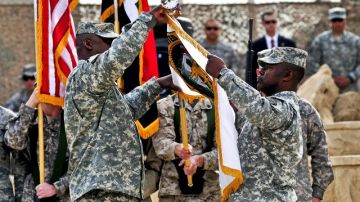 Imagen cedida por el departamento de Defensa de Estados Unidos que muestra al general Lloyd James Austin III (izda) y al comandante Joseph R. Allen, recogiendo la bandera durante el acto que marcó el fin de la operación "Nuevo Amanecer" en la base aérea Sather de Bagdad, Irak, el 15 de diciembre del 2011.