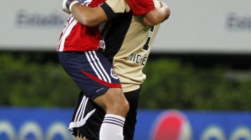 Jonny Magallón y el arquero Luis Michel de Chivas, que tratará de borrar en la Copa Libertadores su mala actuación del torneo local.