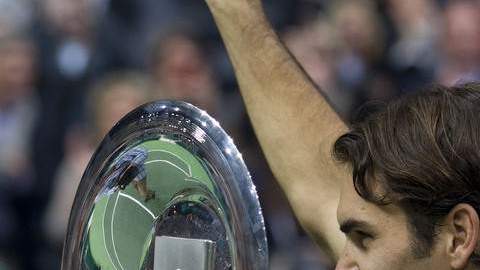 Federer alza su primer trofeo del año y saluda a sus seguidores.