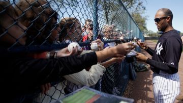 El cerrador Mariano Rivera, aparece firmando autógrafos, a su llegada ayer al campo de entrenamiento de los Yankees, en Tampa.
