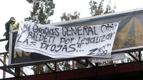 Trabajadores de la municipalidad de Ciudad Guatemala quitan una 'narcomanta', puesta por supuestos miembros de Los Zetas, ayer.