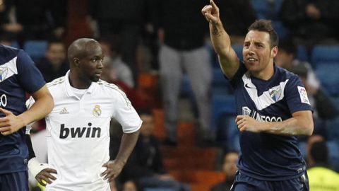 Santi Cazorla (der.) celebra su gol ante la mirada del defensa francés del Real Madrid, Lassana Diarra, ayer en el Santiago Bernabéu.