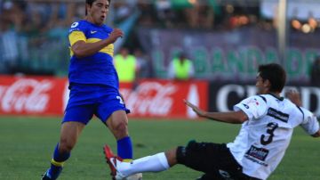 Facundo Roncaglia (izq.). del Boca, pelea el balón con Emmanuel Mas, del San Martín, ayer en el estadio del Bicentenario en San Juan.