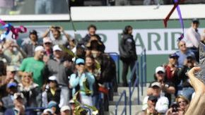 Roger Federer alza feliz  su trofeo agradeciendo la ovación de la concurrencia  que le aplaude de pie.