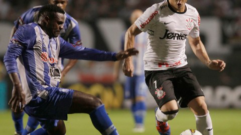 Willian, de Corinthians (d), controla el balón, ante la marca de José Luis Quiñónez, de Emelec, en el partido disputado en Sao Paulo que el conjunto brasileño ganó por 3-0, resultado con el que eliminó de la Copa Libertadores al equipo guayaquileño.