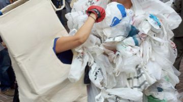Activistas hacen una parodia sobre la batalla perdida de las bolsas de plastico contra las bolsas reciclables.