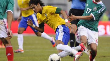 El joven astro Neymar (centro) de Brasil recibe la dura marcación del mexicano  Jesus Zavala (der.) durante el choque amistoso celebrado ayer en Texas.