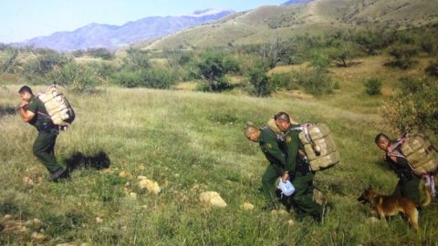 Agentes de la Patrulla Fronteriza cargan bultos de marihuana  tras un hallazgo en la peligrosa y extensa área.