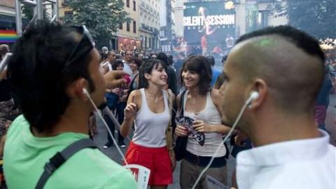 Jóvenes escuchan música en sus teléfonos celulares.