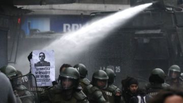 La policía utilizó cañones de gas lacrimógeno y agua para dispersar a cientos de manifestantes anti-Pinochet en protesta por el estreno de un documental, que lo muestra como héroe nacional.