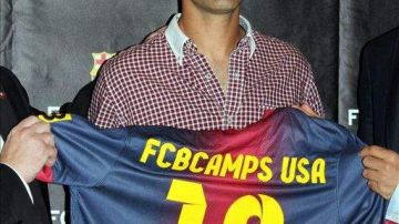 El exjugador del FC Barcelona Rafa Márquez muestra una camiseta del club azulgrana durante la presentación en Nueva York.