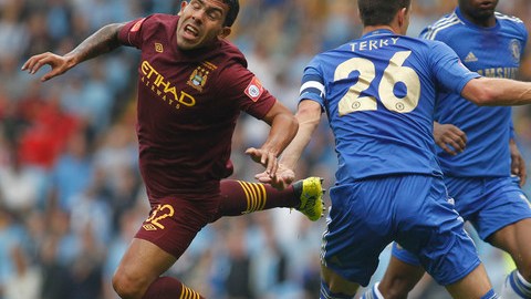 El argentino Carlos Tevez (izq.), del Manchester City, va rumbo al suelo tras chocar con John Terry (26), del Chelsea, en el partido escenificado ayer.
