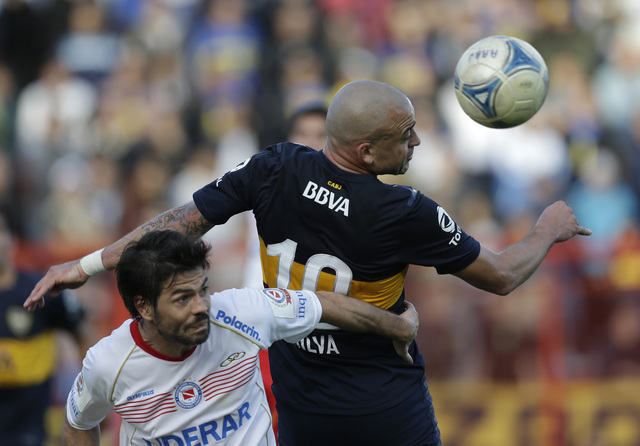 Santiago Silva de Boca rechaza ante la marcación de Ariel Garce de Argentinos Juniors durante la fecha anterior que terminó 1-1.