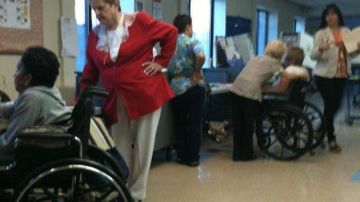 La asambleísta Carmen Arroyo interactuando con votantes en el colegio electoral.