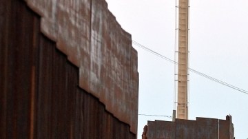 This Aug. 9, 2012, photo shows the border fence with security camera towers in the distance in Nogales, Mexico. The location is near the site where a U.S. Border Patrol agent being pelted with rocks opened fire toward Mexico, killing a 16-year-old boy. The shooting has prompted renewed outcry over the Border Patrol's use-of-force policies and angered human rights activists and Mexican officials who believe the incident has become part of a disturbing trend along the border _ gunning down rock-throwers rather than using non-lethal weapons. (AP Photo/Ross D. Franklin)