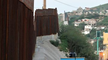 This Aug. 9, 2012, photo shows the border fence with security camera towers in the distance in Nogales, Mexico. The location is near the site where a U.S. Border Patrol agent being pelted with rocks opened fire toward Mexico, killing a 16-year-old boy. The shooting has prompted renewed outcry over the Border Patrol's use-of-force policies and angered human rights activists and Mexican officials who believe the incident has become part of a disturbing trend along the border _ gunning down rock-throwers rather than using non-lethal weapons. (AP Photo/Ross D. Franklin)