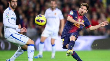 El astro argentino Lionel Messi (d), marca su segunda anotación al Zaragoza en el partido disputado ayer en el Camp Nou de Barcelona.