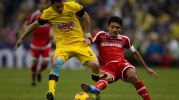 Rubén Sambueza disputa el balón con Antonio Naelson "Sinha" en el partido de ida entre Toluca y América.