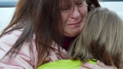 Una madre abraza a su hija tras la masacre ocurrida en la escuela primaria Sandy Hook, en Newtown, Connecticut.