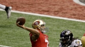 El quarterback Colin Kaepernick (7) de los San Francisco 49ers lanza un pase mientras que el linebacker  de los Ravens de Baltimore, Dannell Ellerbe (59), corre durante la segunda mitad del Super Bowl jugado ayer en Nueva Orleáns. Fue un loco Super Bowl que tuvo hasta un insólito apagón que provocó una demora de 34 minutos.