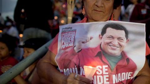 Una seguidora de Chávez carga con una imagen del mandatario durante una vigilia llevada a cabo ayer en Caracas.