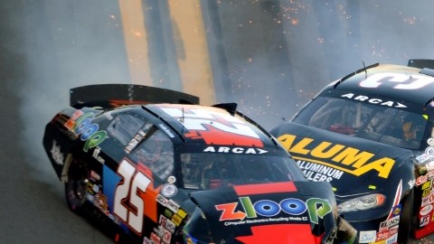 Justin Boston (25) and Drew Charlson (3) slide along the front apron after colliding during the ARCA Series auto race at Daytona International Speedway in Daytona Beach, Fla., Saturday, Feb. 16, 2013.