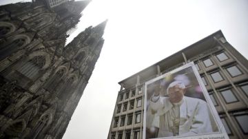 Vista de un edificio de cuatro plantas que muestra un cartel gigante con un retrato del papa Benedicto XVI junto a la catedral de Colonia (Alemania) el lunes 25 de febrero de 2013.