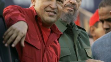 FILE - In this  July 21, 2006 file photo, Venezuela's President Hugo Chavez, left, gestures as Cuba's President Fidel Castro looks on during an event  in Cordoba, Argentina. Venezuela's Vice President Nicolas Maduro announced on Tuesday, March 5, 2013 that Chavez has died at age 58 after a nearly two-year bout with cancer. (AP Photo/Roberto Candia, File)