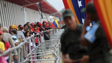 Decenas de personas cuando ayer hacían  fila para visitar la capilla ardiente del líder venezolano Hugo Chávez, en Caracas.