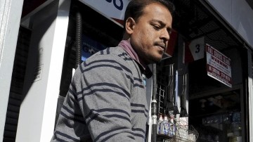Un hombre echa  combustible a su carro en una gasolinera, en Brooklyn, Nueva York, Estados Unidos.