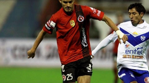 Ronald Puma, del San José, intenta despojar del balón a Daniel Márquez, de Xolos, en la altura de Oruro.