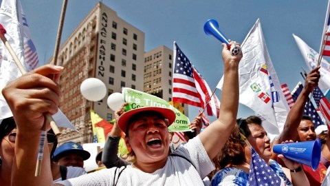 Alma Banuelos, left, with Emilia Hernandez  shout slogans during a rally in downtown Los Angeles Wednesday, May 1, 2013. In celebration of May Day thousands have gathered for an immigration reform rally in downtown Los Angeles. (AP Photo/Nick Ut)
