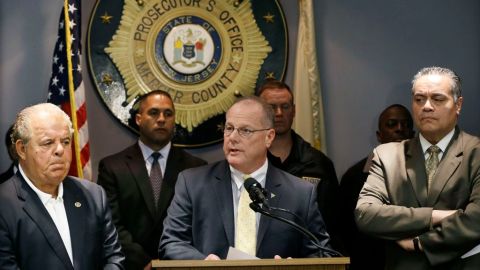 El fiscal del condado de Mercer, Joseph L. Bocchini Jr. (izq.), y el director de la Policía de Trenton, Ralph Rivera Jr. (der.), escuchan al superintendente de la Policía Estatal de Nueva Jersey, Rick Fuente, durante la rueda de prensa sobre el caso de rehenes en Trenton.