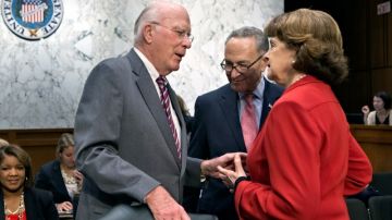 FILE - In this May 20, 2013 file photo, Senate Judiciary Committee Chairman Patrick Leahy, D-Vt., left, confers with Sen. Chuck Schumer, D-N.Y., center, and Sen. Dianne Feinstein, D-Calif., as the Senate Judiciary Committee assembled to work on a landmark immigration bill to secure the border and offer citizenship to millions, on Capitol Hill in Washington. Leading senators working on immigration legislation reached a compromise Tuesday on the details of an expanded high-tech visa program, officials said as the Senate Judiciary Committee neared completion of its work on the measure. At the same time, several officials said the White House has made it known to Leahy that it would prefer postponing a showdown over the rights of same sex spouses until a vote in the full Senate.  (AP Photo/J. Scott Applewhite, File)