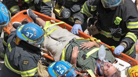 Rescatistas auxilian a uno de los sobrevivientes del derrumbe.