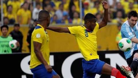 Lionel Messi  realiza un disparo ante Frickson Erazo  y Jorge Guagua, de Ecuador,  en el duelo por las eliminatorias sudamericanas.