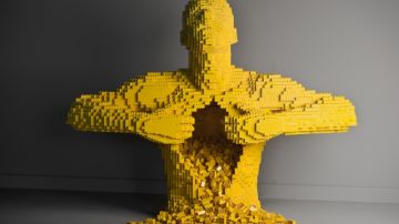 Figura humana  hecha con miles de legos amarillos.