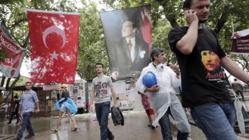 Activistas caminan con   una enorme bandera turca en el parque Gezi en Estambul, Turquía.