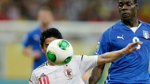 Shinji Kagawa y Mario Balotelli disputan el esférico