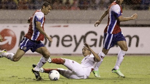 Rolando Escobar cae al intentar frenar al tico Celso Borges (izq.) en jugada de ayer en San José.