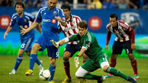 Dan Kennedy, portero de Chivas USA,  es exigido en   acción ofensiva del italiano   Marco Di Vaio, durante el partido de ayer en Montreal.
