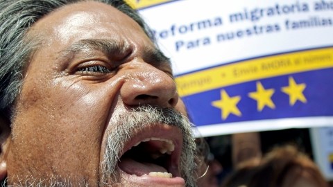 Juan Muñoz Hernandez shouts during a demonstration in favor of immigration and citizenship reform legislation, in front of a regional Republican Party headquarters in Burbank, Calif., Tuesday, July 9, 2013. (AP Photo/Sarah Parvini)