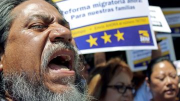 Juan Muñoz Hernandez shouts during a demonstration in favor of immigration and citizenship reform legislation, in front of a regional Republican Party headquarters in Burbank, Calif., Tuesday, July 9, 2013. (AP Photo/Sarah Parvini)