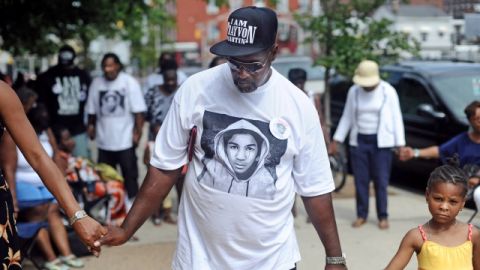 David Walls and over 100 protesters gathered for a demonstration against the verdict in the Trayvon Martin case Sunday, July 21, 2013 in front of Passaic City Hall. The protest began with everyone joining hands. (AP Photo/The Record, Tyson Trish)