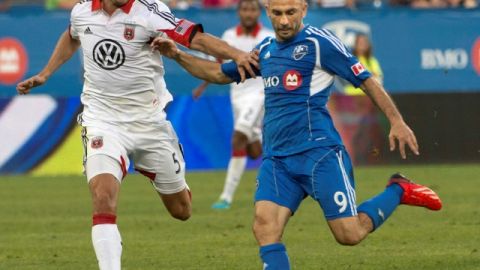 El defensor Dejan Jakovic (izq.), del DC United, no puede frenar a Marco Di Vaio, autor de los dos goles  del Impact de Montreal.