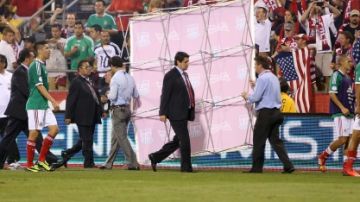Luis Fernando Tena, director técnico de México, y otros jugadores abandonaron el campo de juego con protección luego de perder frente a Estados Unidos 2-0.