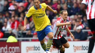 Mesut Özil, del Arsenal (izq), en su estreno en la liga Premier, evade la marca de David Vaughan, del Sunderland, en el partido disputado en 'Stadium of Light'.