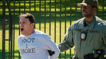 Uno de los siete activistas en el momento que fue arrestado en la mañana del miércoles tras amarrarse a la reja de la Casa Blanca.