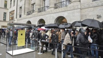 Consumidores esperan para entrar a una tienda Apple en Berlín, Alemania.