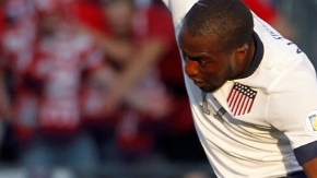 U.S. forward Jozy Altidore, top, jumps to avoid Jamaica defender Adrian Mariappa during the first half of a World Cup qualifier soccer match at Sporting Park in Kansas City, Kan., Friday, Oct. 11, 2013. (AP Photo/Colin E. Braley)